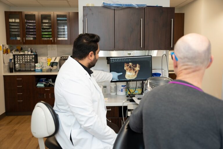 Dr. Nitin Jaggi explaining dental implants procedure to patient at Eastside Modern Dentistry Issaquah WA 768x513