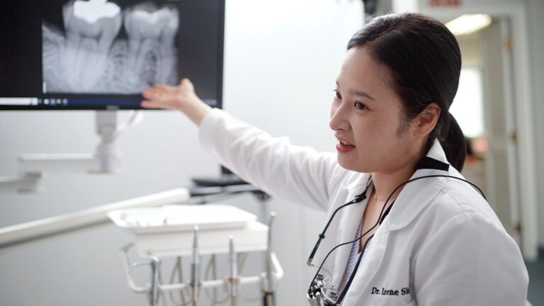 Alexandria dentist Dr. Irene Shin explaining root canal procedure with dental patient at U Shine Dental Old Town 768x432
