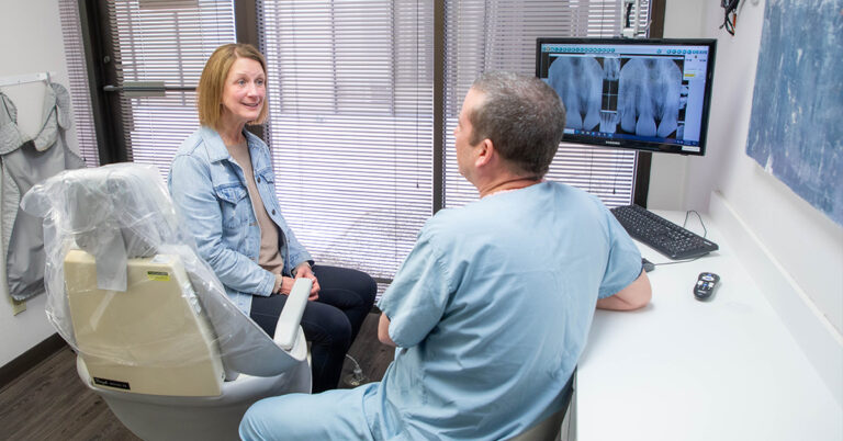 Scottsdale dentist Dr. Alex Martin explaining dental implants procedure to patient 768x402